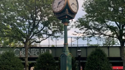 Historic clock surrounded by public seating in plaza in downtown Cranford, New Jersey.